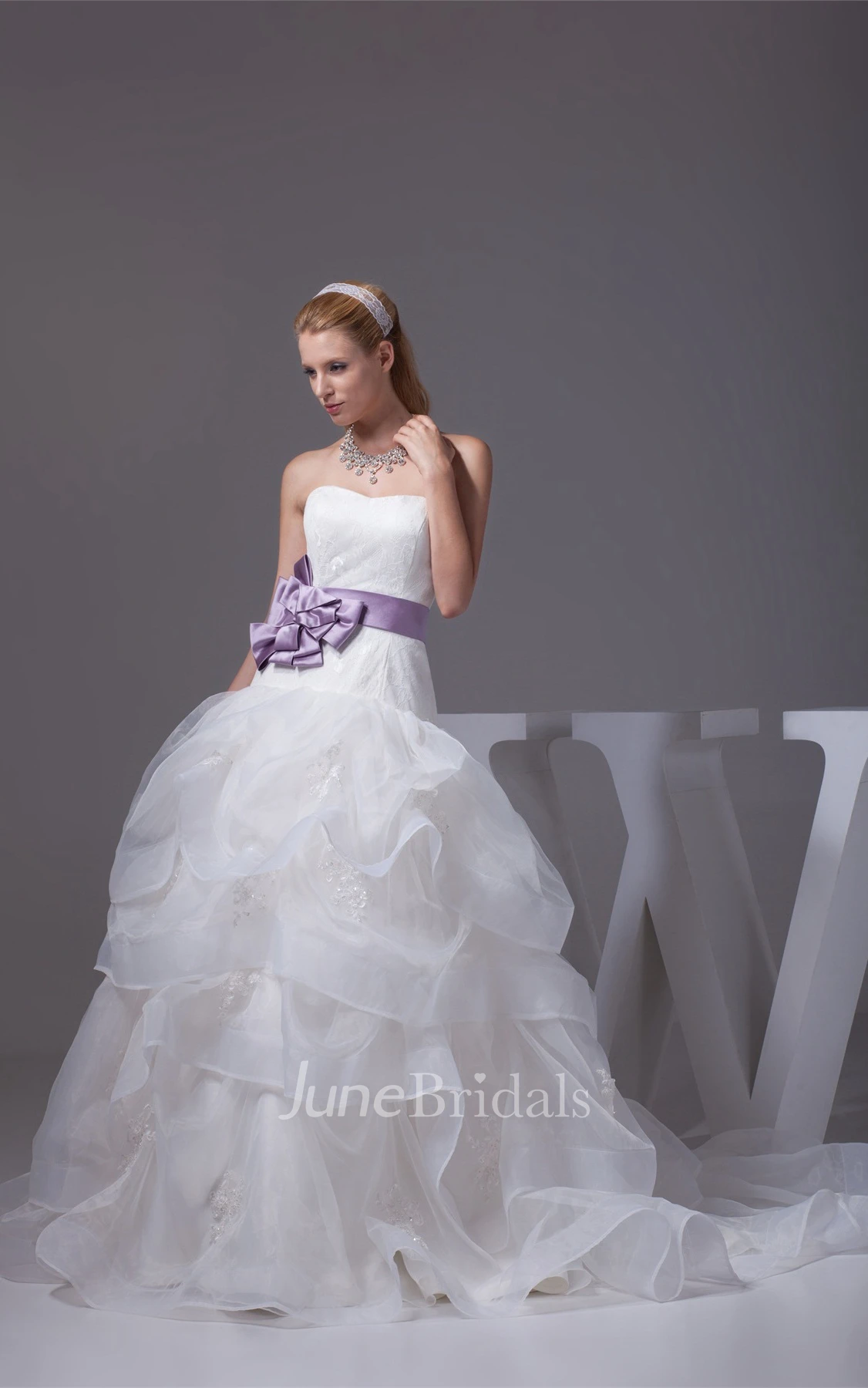 Strapless Ruffled Ball Gown with Bow and Appliques