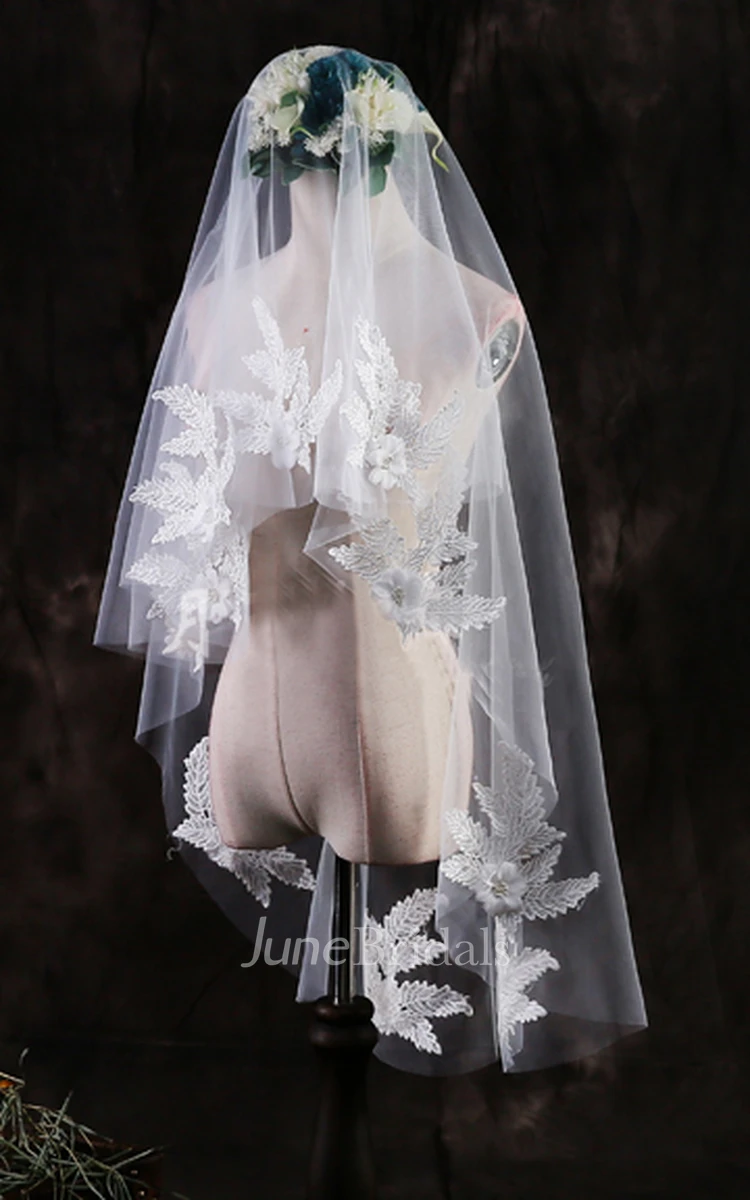 Handmade white 49” selling length veil with white lace appliqué trim.